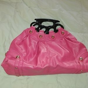 Bag with brass knuckle style handles